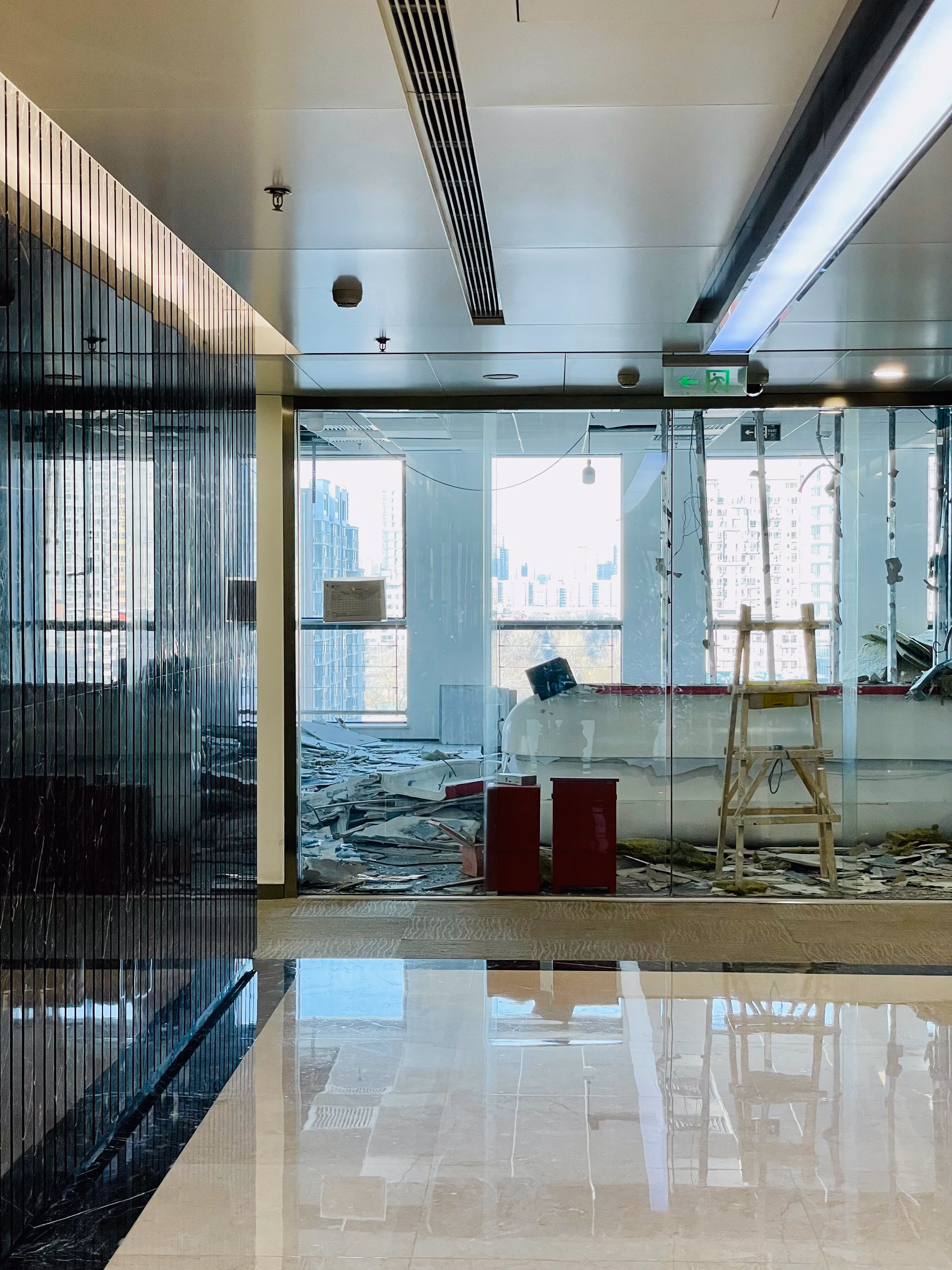 Bright and modern office in renovation with city skyline visible through large windows